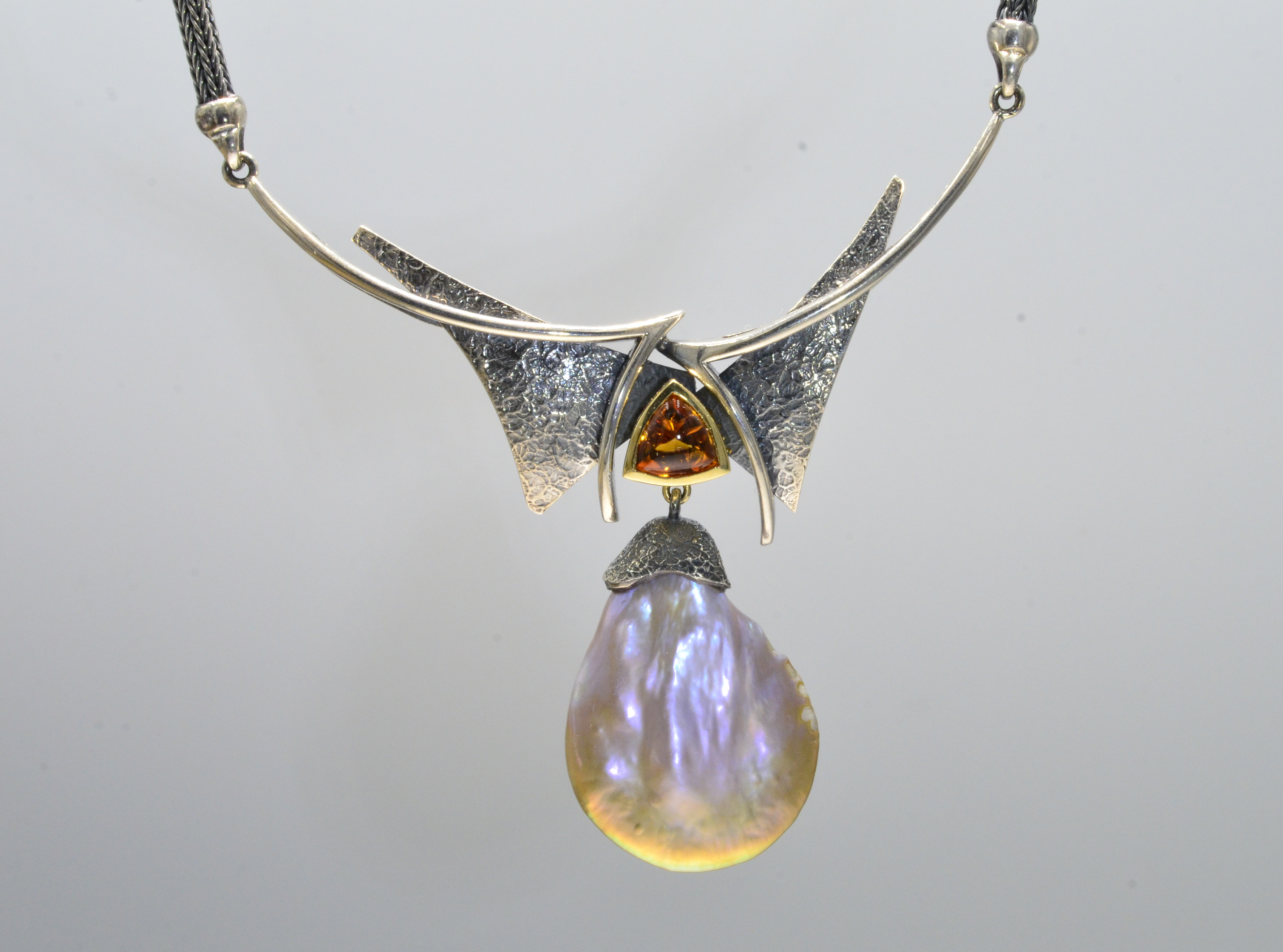 Multi Angular Pendant. The Freshwater Pearl has a soft Pink/Rose sheen. The Citrine is smooth on top and faceted on the bottom half creating a glowing orange Characteristic. Width 2.3/4 " Height 2.25 ".  Width of chain 3.5 mm and attached to the Pendant, 19"total length.